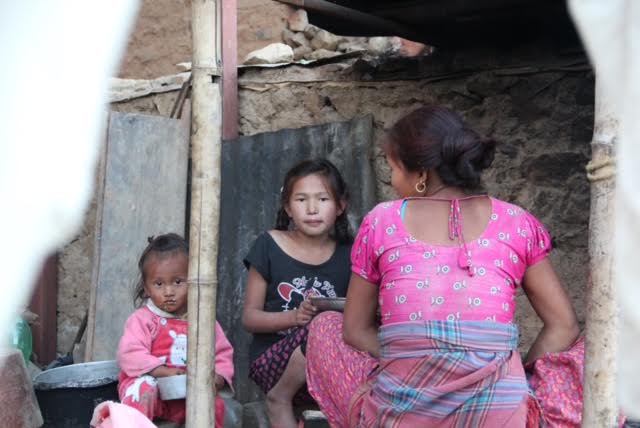 Susali in her home (in the dark coloured T-shirt)